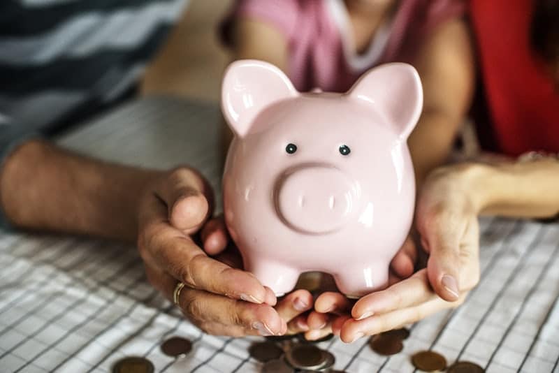Couple holding piggy bank