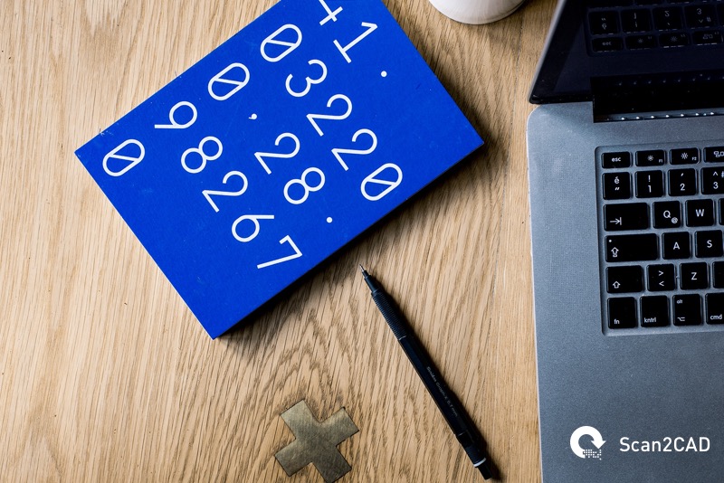 numbers on notepad, pen and laptop on desk
