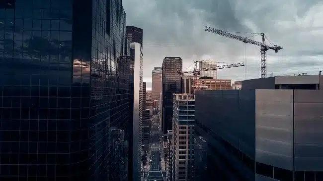 High rise buildings with cranes in distance